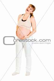 Laughing pregnant woman holding her tummy isolated on white
