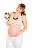 Baby on way! Smiling pregnant woman holding alarm clock
