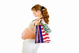 Pregnant woman holding shopping bags in hand
