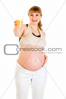 Happy pregnant woman holding glass of juice in hand
