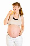 Happy beautiful pregnant woman drinking orange juice 
