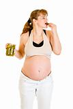  Pregnant woman eating pickles with relish. Concept - little whims!
