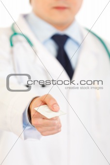 Doctor giving condom. Close-up.
