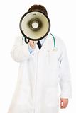Doctor standing in front of camera and speaking into megaphone

