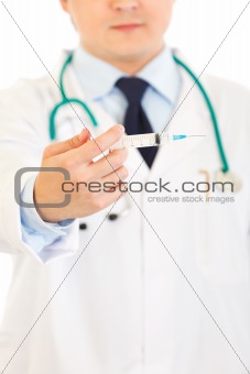 Doctor with medical syringe in hands. Close-up.

