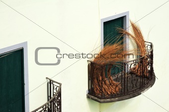 Balcony at old house in Madeira with package of wicker