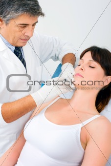 young caucasian woman receiving an injection of botox from a doctor