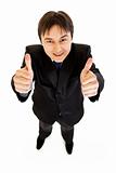 Smiling young businessman showing  thumbs up gesture
