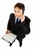 Smiling young businessman with headset holding clipboard
