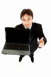 Smiling modern businessman holding laptops blank screen and showing  thumbs up gesture
