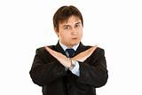 Confident businessman with crossed arms. Forbidden gesture

