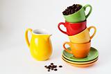 Colorful cups and yellow jug