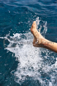 Foot of young man in water - splash