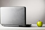 laptop with green fresh apple