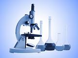 Laboratory metal microscope and test tubes with liquid toning in