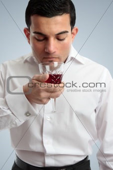 Man smelling red wine