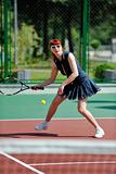 young woman play tennis game outdoor