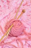 Sphere of pink wool with needles
