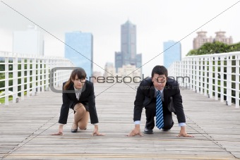 Business man and woman  getting ready for race in business