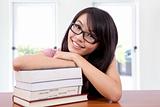 Beautiful smiling girl in a classroom with book