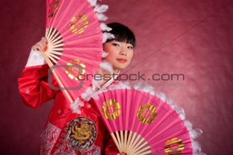 Asian woman in traditional dress with the fan