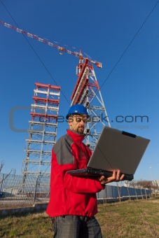Engineer with Computer in Construction Site