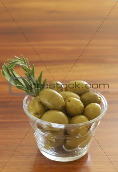 Jar of green olives and rosemary