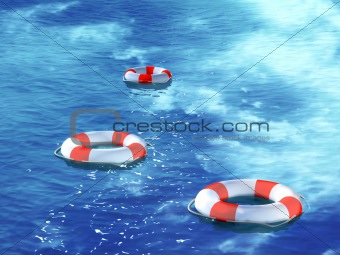 Three lifebuoys, floating on waves