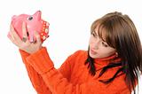 Young woman standing with piggy bank