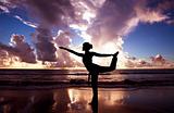Yoga woman on the beautiful beach at sunrise