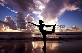 Yoga woman on the beautiful beach at sunrise