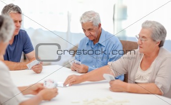Retired people playing cards together