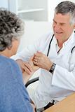 A senior doctor doing an examination of his patient 