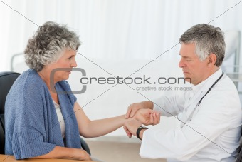 A senior doctor doing an examination of his patient 