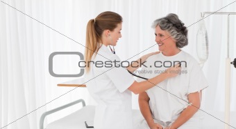 Nurse taking the heartbeat of her patient