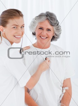 Retired patient with her nurse looking at the camera