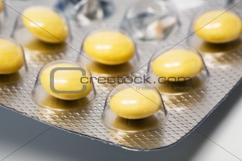 Yellow and round pills
