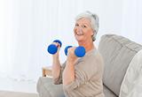 Senior doing her exercises on her sofa