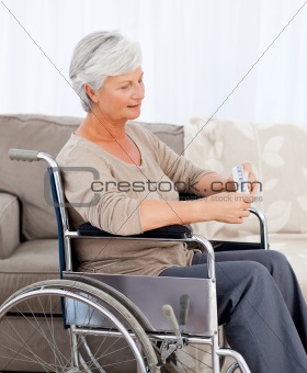 Senior in wheelchair with pills