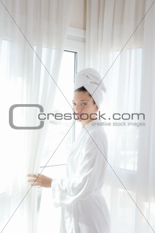 Bathrobe woman sunny window white curtains