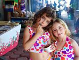 sister little girls eating chocolate ice cream summer