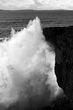 giant wave crashing on coastline cliffs