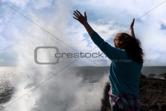 silhouette of lone woman facing a giant powerful wave 