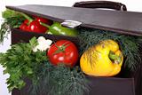 Brown briefcase with ripe fresh vegetables