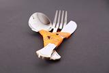 Fork, knife and spoon with orange ribbon