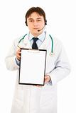 Authoritative medical doctor with headset holding blank clipboard
