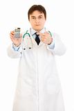 Authoritative medical doctor pointing finger on calculator
