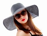 Young woman in black hat and sunglasses 