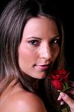 Beautiful young woman with red rose