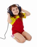 Little girl listens to music